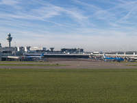 Aerial panoramic view of Amsterdam Airport Schiphol AMS EHAM from a departing airplane window with a JetBlue Airbus A321LR and a Boeing 737...