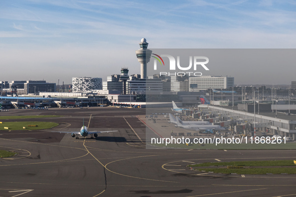 Aerial panoramic view of Amsterdam Airport Schiphol AMS EHAM from a departing airplane window. Aircraft, airport terminal, cargo terminal, r...