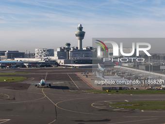 Aerial panoramic view of Amsterdam Airport Schiphol AMS EHAM from a departing airplane window. Aircraft, airport terminal, cargo terminal, r...