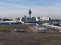 Aerial panoramic view of Amsterdam Airport Schiphol AMS EHAM from a departing airplane window. Aircraft, airport terminal, cargo terminal, r...