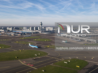 Aerial panoramic view of Amsterdam Airport Schiphol AMS EHAM from a departing airplane window. Aircraft, airport terminal, cargo terminal, r...