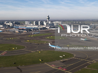 Aerial panoramic view of Amsterdam Airport Schiphol AMS EHAM from a departing airplane window. Aircraft, airport terminal, cargo terminal, r...