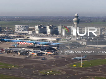 Aerial panoramic view of Amsterdam Airport Schiphol AMS EHAM from a departing airplane window. Aircraft, airport terminal, cargo terminal, r...