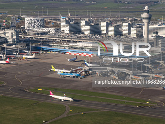 Aerial panoramic view of Amsterdam Airport Schiphol AMS EHAM from a departing airplane window. Aircraft, airport terminal, cargo terminal, r...