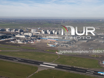 Aerial panoramic view of Amsterdam Airport Schiphol AMS EHAM from a departing airplane window with a KLM Boeing 737 aircraft on the runway r...