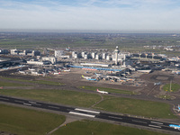 Aerial panoramic view of Amsterdam Airport Schiphol AMS EHAM from a departing airplane window with a KLM Boeing 737 aircraft on the runway r...