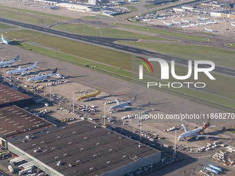 Aerial panoramic view of Amsterdam Airport Schiphol AMS EHAM from a departing airplane window with Cargo terminal and cargo planes. Aircraft...