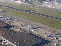 Aerial panoramic view of Amsterdam Airport Schiphol AMS EHAM from a departing airplane window with Cargo terminal and cargo planes. Aircraft...