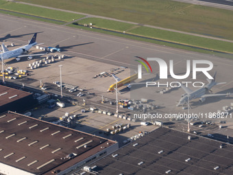 Aerial panoramic view of Amsterdam Airport Schiphol AMS EHAM from a departing airplane window with Cargo terminal and cargo planes like Qata...