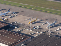 Aerial panoramic view of Amsterdam Airport Schiphol AMS EHAM from a departing airplane window with Cargo terminal and cargo planes like Qata...