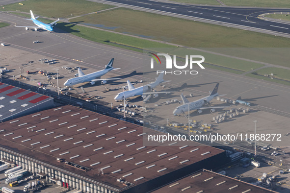 Aerial panoramic view of Amsterdam Airport Schiphol AMS EHAM from a departing airplane window with Cargo terminal and Boeing 747 cargo plane...