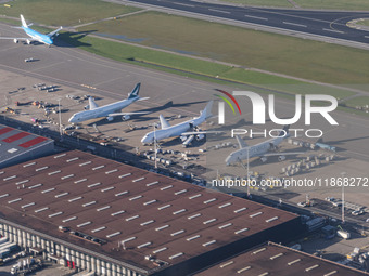 Aerial panoramic view of Amsterdam Airport Schiphol AMS EHAM from a departing airplane window with Cargo terminal and Boeing 747 cargo plane...