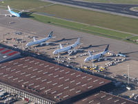 Aerial panoramic view of Amsterdam Airport Schiphol AMS EHAM from a departing airplane window with Cargo terminal and Boeing 747 cargo plane...