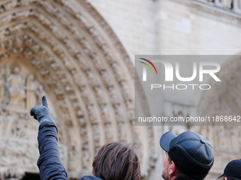 The public admires Notre-Dame Cathedral a few days after its reopening to the public. (