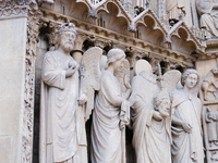 Statues of saints, kings, and angels are on Notre Dame Cathedral. (