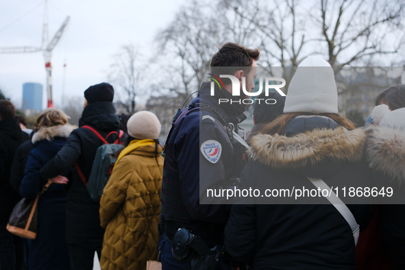 A police officer monitors the queue to visit Notre Dame Cathedral. 