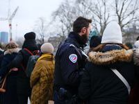 A police officer monitors the queue to visit Notre Dame Cathedral. (