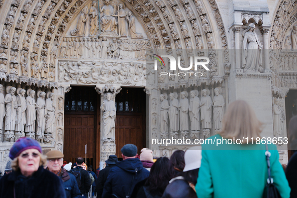 Visitors now approach the doors of Notre-Dame. 