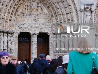 Visitors now approach the doors of Notre-Dame. (