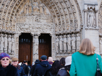 Visitors now approach the doors of Notre-Dame. (