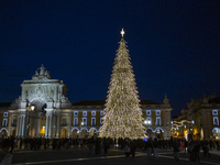 People gather around the Christmas lights at Praca do Comercio in Lisbon, Portugal, on December 14, 2024. The Christmas lights in Lisbon are...