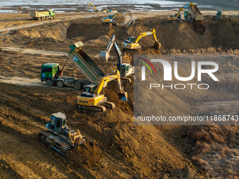 Workers work at the Qingjiangpu section of the second phase of the Huaihe River Waterway project in Huai 'an City, Jiangsu Province, on Dece...