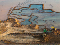 Workers work at the Qingjiangpu section of the second phase of the Huaihe River Waterway project in Huai 'an City, Jiangsu Province, on Dece...