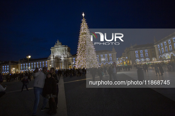 In Lisbon, Portugal, on December 14, 2024, people take a selfie around the Christmas lights at Praca do Comercio. The Christmas lights in Li...