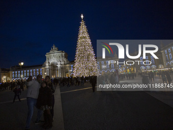 In Lisbon, Portugal, on December 14, 2024, people take a selfie around the Christmas lights at Praca do Comercio. The Christmas lights in Li...