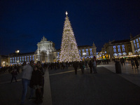 In Lisbon, Portugal, on December 14, 2024, people take a selfie around the Christmas lights at Praca do Comercio. The Christmas lights in Li...