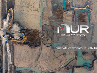 Workers work at the Qingjiangpu section of the second phase of the Huaihe River Waterway project in Huai 'an City, Jiangsu Province, on Dece...