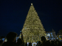 People gather around the Christmas lights at Praca do Comercio in Lisbon, Portugal, on December 14, 2024. The Christmas lights in Lisbon are...