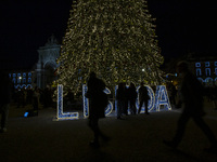 People gather around the Christmas lights at Praca do Comercio in Lisbon, Portugal, on December 14, 2024. The Christmas lights in Lisbon are...