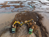 Workers work at the Qingjiangpu section of the second phase of the Huaihe River Waterway project in Huai 'an City, Jiangsu Province, on Dece...