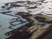 Workers work at the Qingjiangpu section of the second phase of the Huaihe River Waterway project in Huai 'an City, Jiangsu Province, on Dece...