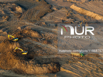 Workers work at the Qingjiangpu section of the second phase of the Huaihe River Waterway project in Huai 'an City, Jiangsu Province, on Dece...