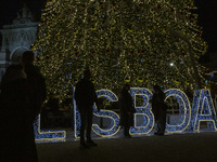 People gather around the Christmas lights at Praca do Comercio in Lisbon, Portugal, on December 14, 2024. The Christmas lights in Lisbon are...