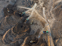 Workers work at the Qingjiangpu section of the second phase of the Huaihe River Waterway project in Huai 'an City, Jiangsu Province, on Dece...