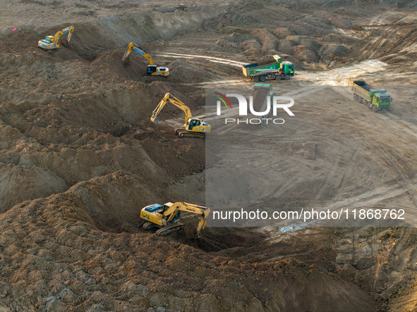 Workers work at the Qingjiangpu section of the second phase of the Huaihe River Waterway project in Huai 'an City, Jiangsu Province, on Dece...