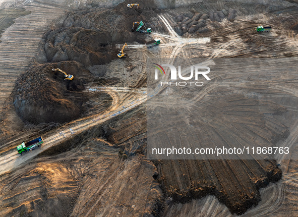 Workers work at the Qingjiangpu section of the second phase of the Huaihe River Waterway project in Huai 'an City, Jiangsu Province, on Dece...