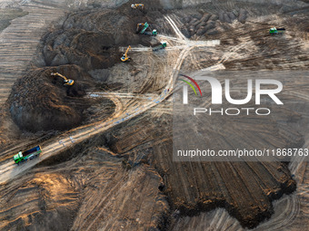 Workers work at the Qingjiangpu section of the second phase of the Huaihe River Waterway project in Huai 'an City, Jiangsu Province, on Dece...