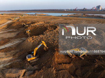 Workers work at the Qingjiangpu section of the second phase of the Huaihe River Waterway project in Huai 'an City, Jiangsu Province, on Dece...