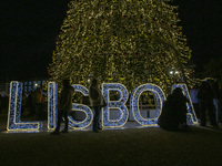 People gather around the Christmas lights at Praca do Comercio in Lisbon, Portugal, on December 14, 2024. The Christmas lights in Lisbon are...