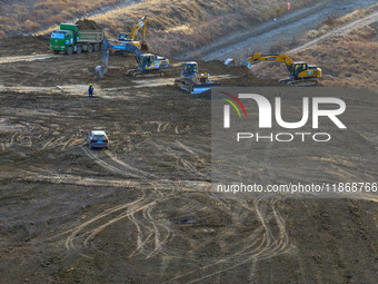 Workers work at the Qingjiangpu section of the second phase of the Huaihe River Waterway project in Huai 'an City, Jiangsu Province, on Dece...