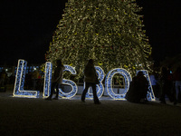 People gather around the Christmas lights at Praca do Comercio in Lisbon, Portugal, on December 14, 2024. The Christmas lights in Lisbon are...