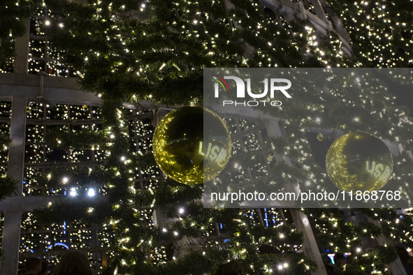 People are reflected around the Christmas lights at Praca do Comercio in Lisbon, Portugal, on December 14, 2024. The Christmas lights in Lis...