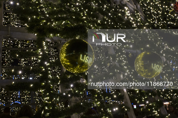 In Lisbon, Portugal, on December 14, 2024, people reflect around the Christmas lights at Praca do Comercio. The Christmas lights in Lisbon a...