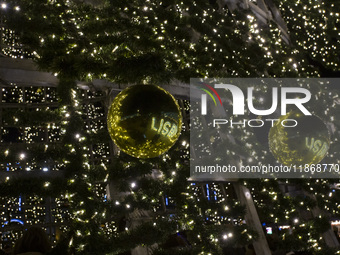 In Lisbon, Portugal, on December 14, 2024, people reflect around the Christmas lights at Praca do Comercio. The Christmas lights in Lisbon a...