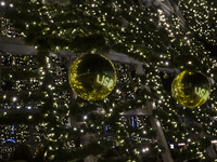 In Lisbon, Portugal, on December 14, 2024, people reflect around the Christmas lights at Praca do Comercio. The Christmas lights in Lisbon a...