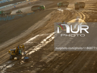 Workers work at the Qingjiangpu section of the second phase of the Huaihe River Waterway project in Huai 'an City, Jiangsu Province, on Dece...